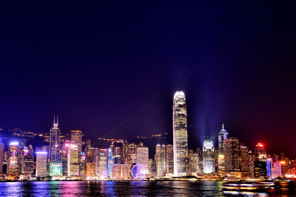 Hong Kong Lasershow auf den Hochhäusern von Hong Kong Island, fotografiert vom Kowloon Public Pier, China, Asien
