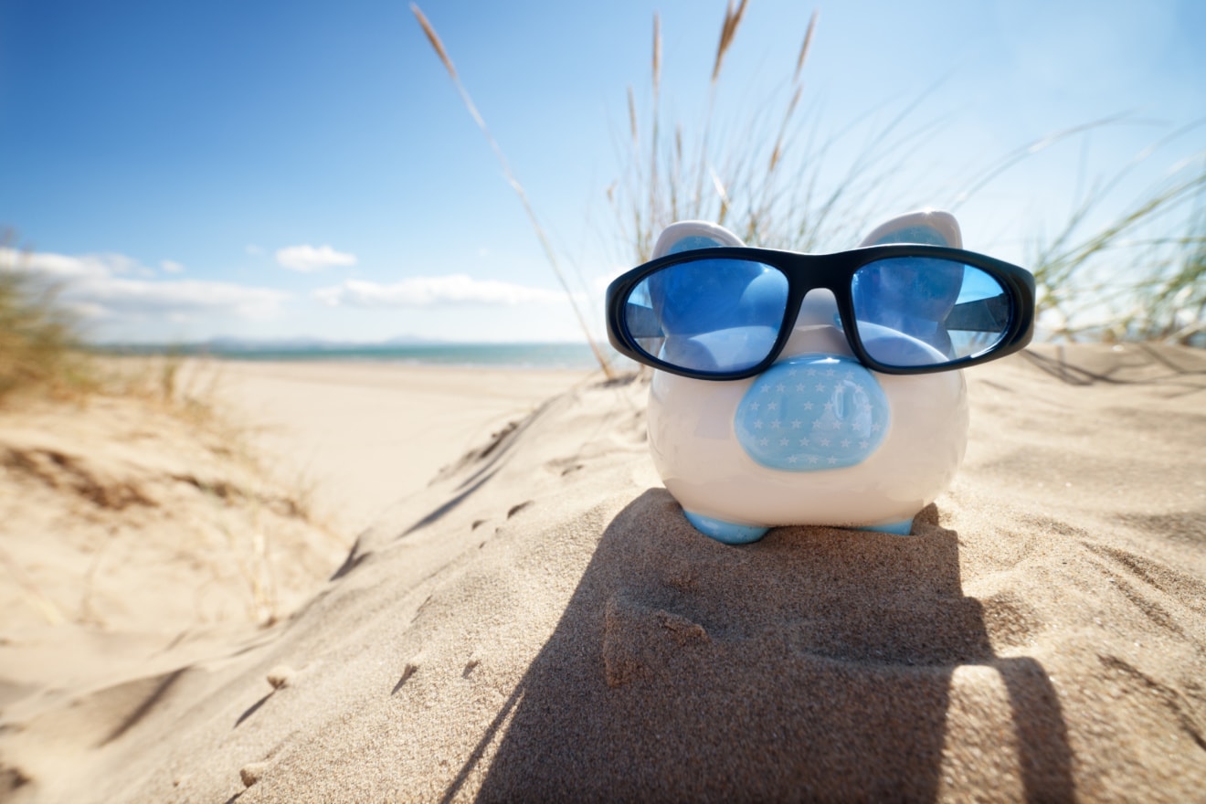 Sparschwein am Strand mit Sonnenbrille