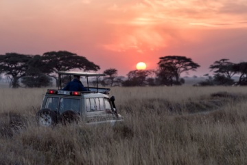 Safari-Auto bei Sonnenaufgang in der Serengeti