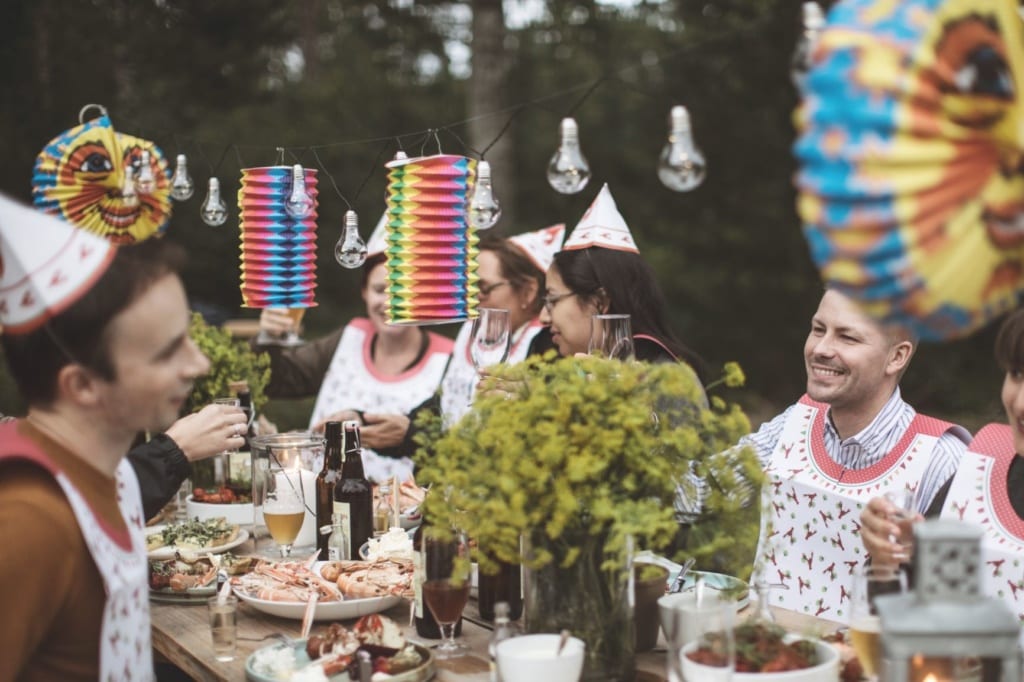 Schweden sitzen am Tisch und feiern das Krebsfest