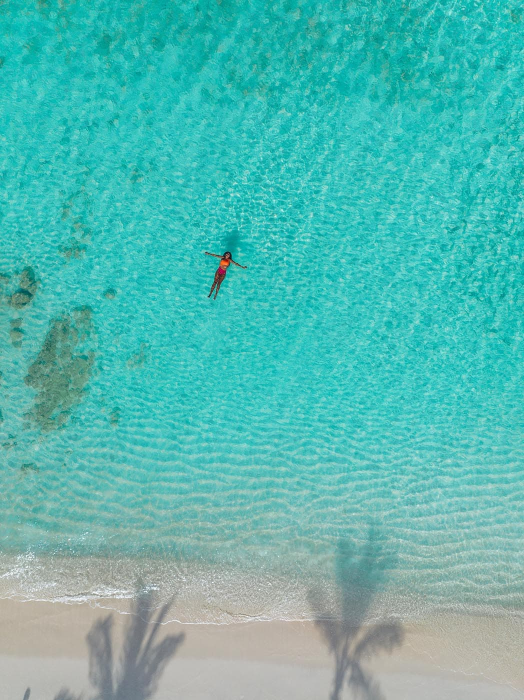 Frau floatet im Meer auf Aruba