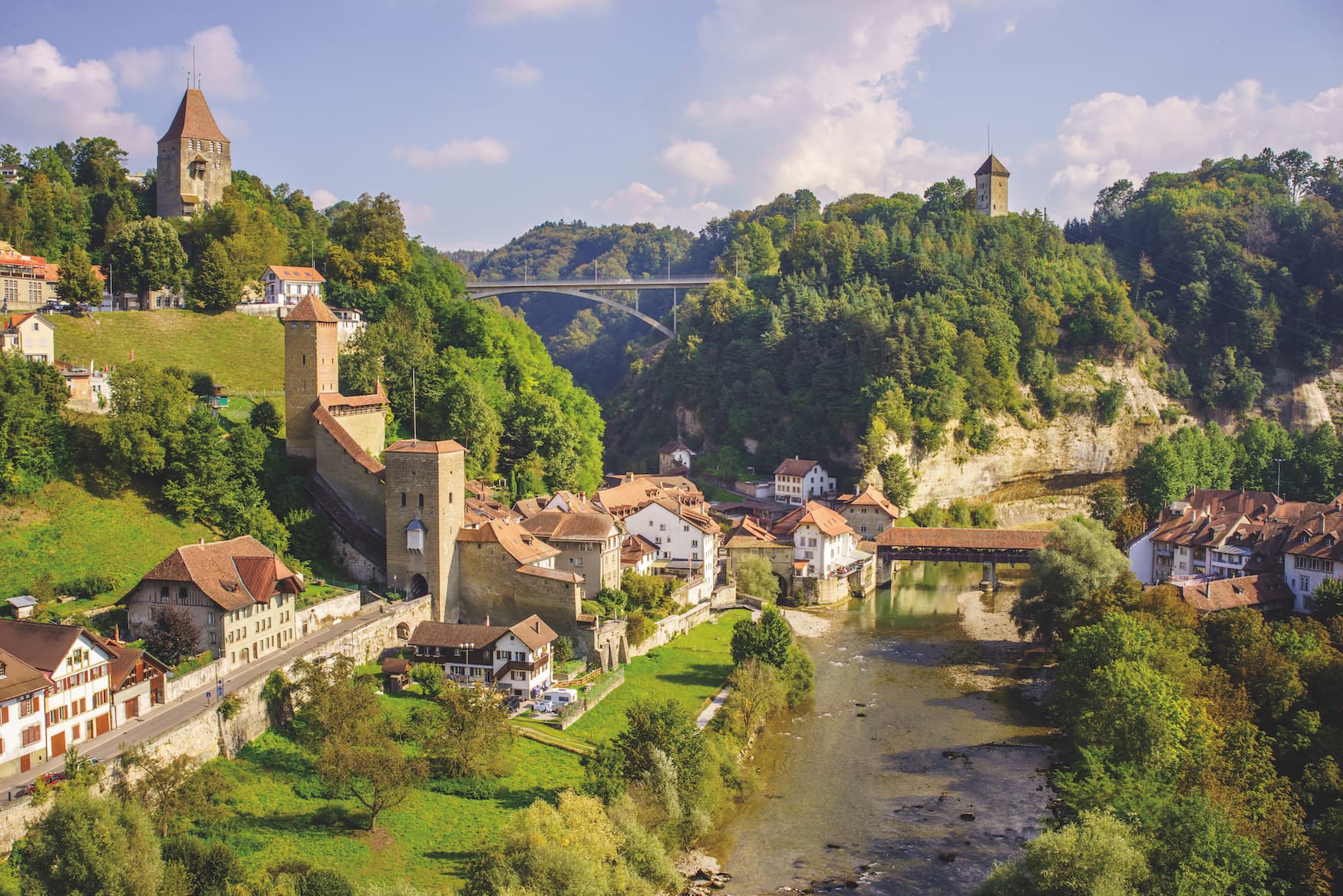 Die Sanne fließt quer die Altstad von Fribourg, mit Blick auf den Katzenturm und die Gottéron-Brücke