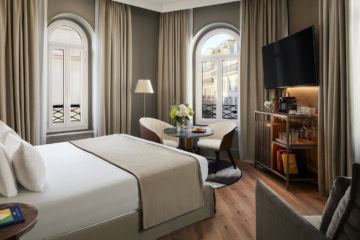 Hotelzimmer mit abgerundeten Fenster mit Blick auf Paris, gedeckte Farben,elegante Einrichtung