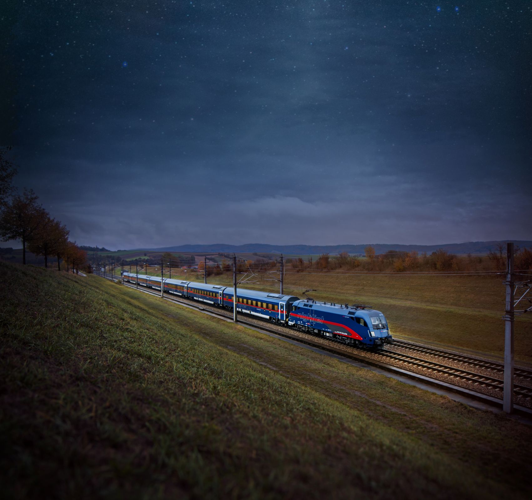 Nightjet der ÖBB auf offener Strecke in der Abenddämmerung