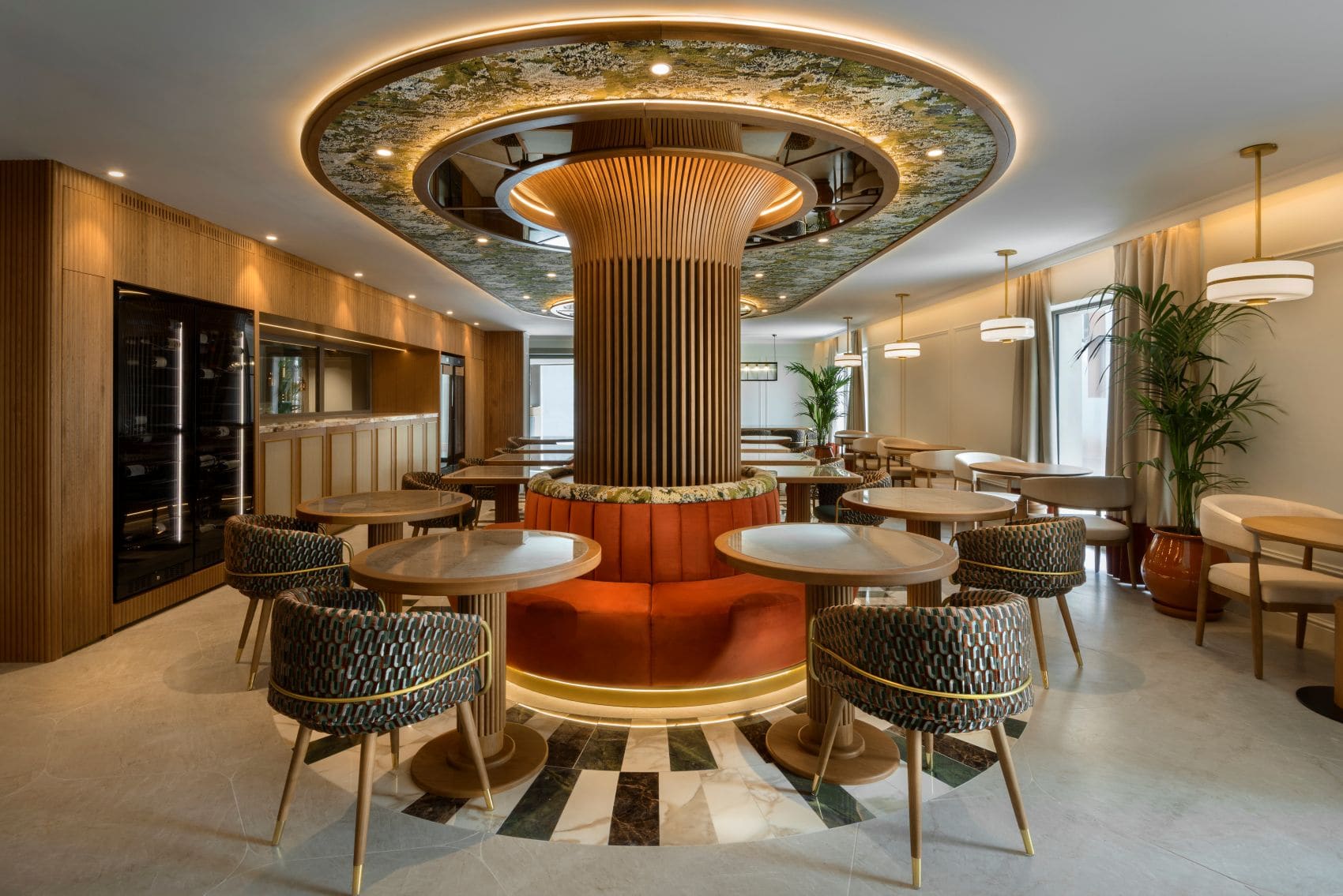 Restaurant Ocra im Palacio San Juan in Murcia mit Holz, Marmor und orangefarbenen Sitzmöbeln.
